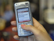 A woman holding a mobile phone (http://www.bbc.co.uk/schools/gcsebitesize/business/images/mobile_phone.jpg)