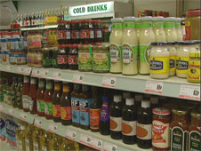 A display of tins and jars on a shelf in a shop (http://www.bbc.co.uk/schools/gcsebitesize/business/images/shop_goods.jpg)