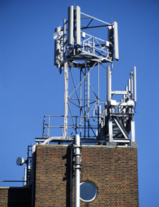 Radio wave antennas mounted on the top of a building  (http://www.bbc.co.uk/schools/gcsebitesize/science/images/ph_waves07.jpg)